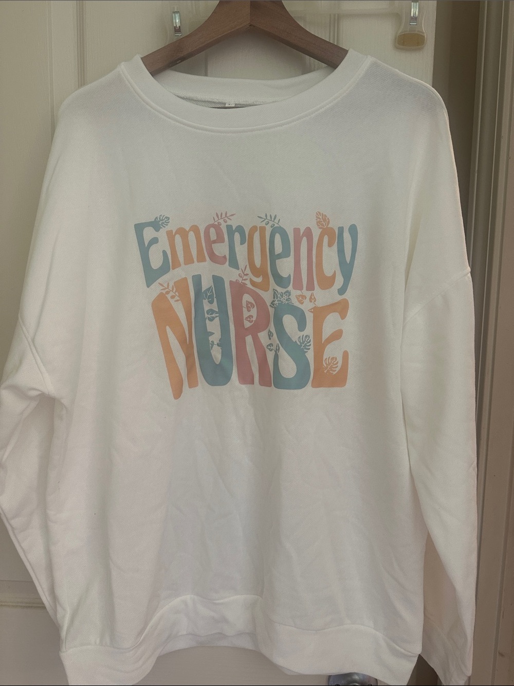 Emergency Nurse Graphic Sweatshirt - White with Pastel Blue & Peach Print